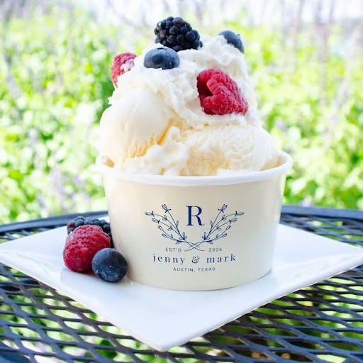 Custom paper dessert cups filled with ice cream, fresh berries, and whipped cream on a table